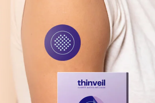 Round wellness patch worn on the upper arm